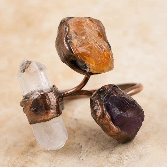 Tri-color gemstone ring featuring amethyst, citrine, and clear quartz with organic raw stone texture.