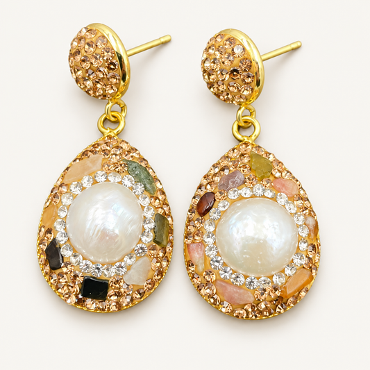 Baroque pearl earrings with freshwater pearl centers, multicolor tourmaline accents and gold-tone teardrop frames on an off-white background.