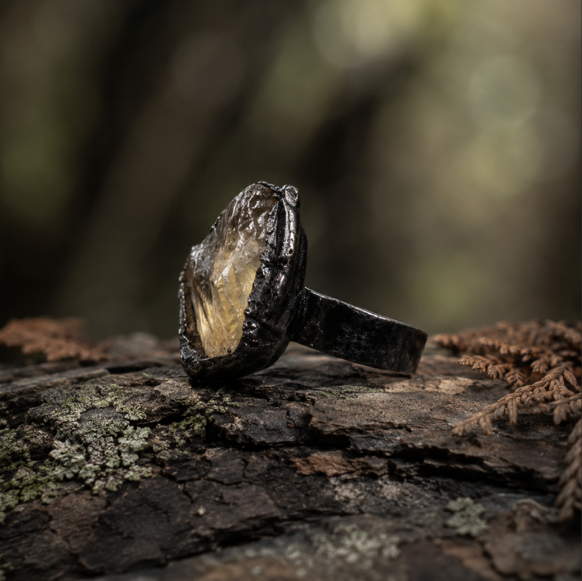 Yellow gemstone ring displayed on mossy wood with warm crystal glow and earthy natural mood.