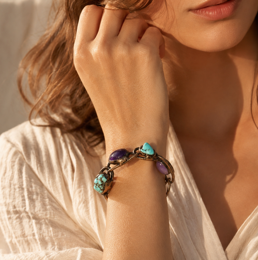 Purple turquoise bracelet styled on the wrist with bold gemstone contrast and bohemian jewelry mood.