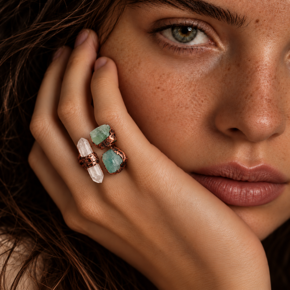 Three stone ring worn on the hand, showing the real scale of clear quartz and two green fluorite stones.