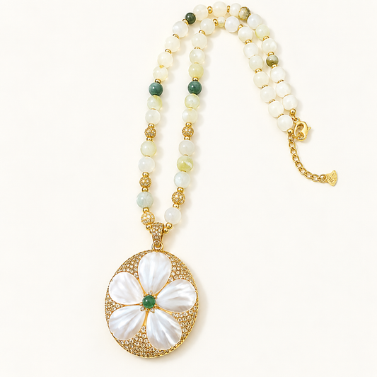 Mother-of-pearl flower necklace with white and green freshwater pearls, a deep green pendant center and gold-tone extension chain.