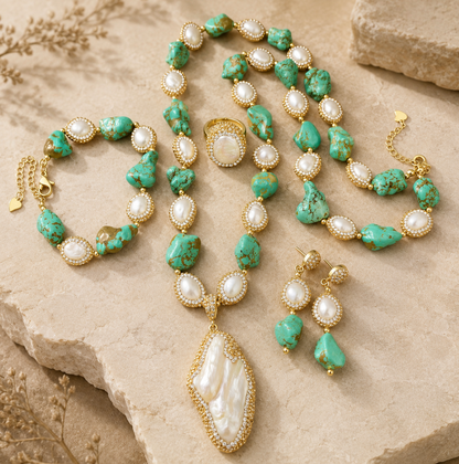 Turquoise jewelry set with baroque pearls, turquoise stones, gold-tone details, and natural sunlight.
