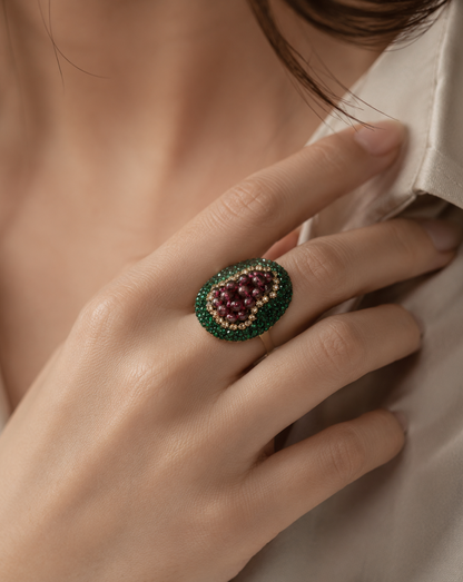 Close-up of garnet stone ring featuring delicate grape cluster design