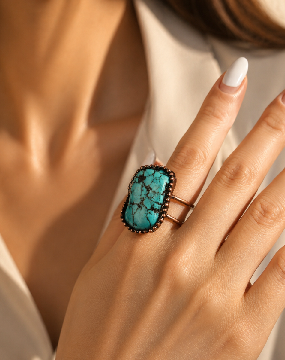 Turquoise statement ring with bold oval stone, organic lines, and elegant everyday styling.