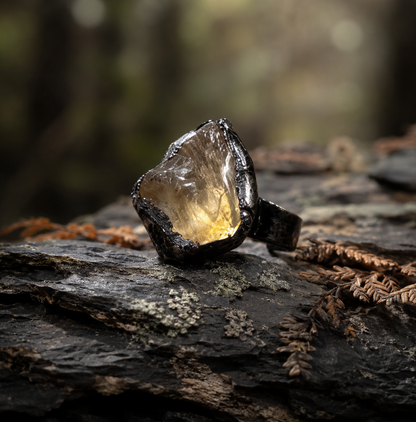 Citrine ring with raw golden-yellow crystal, organic texture, and dark forest-inspired styling.