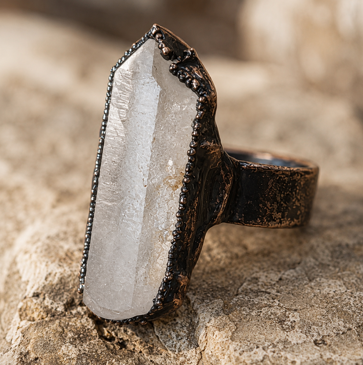 Quartz crystal ring with raw clear crystal form, geometric silhouette, and quiet modern elegance.