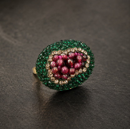 Close-up of garnet ring featuring delicate grape cluster design