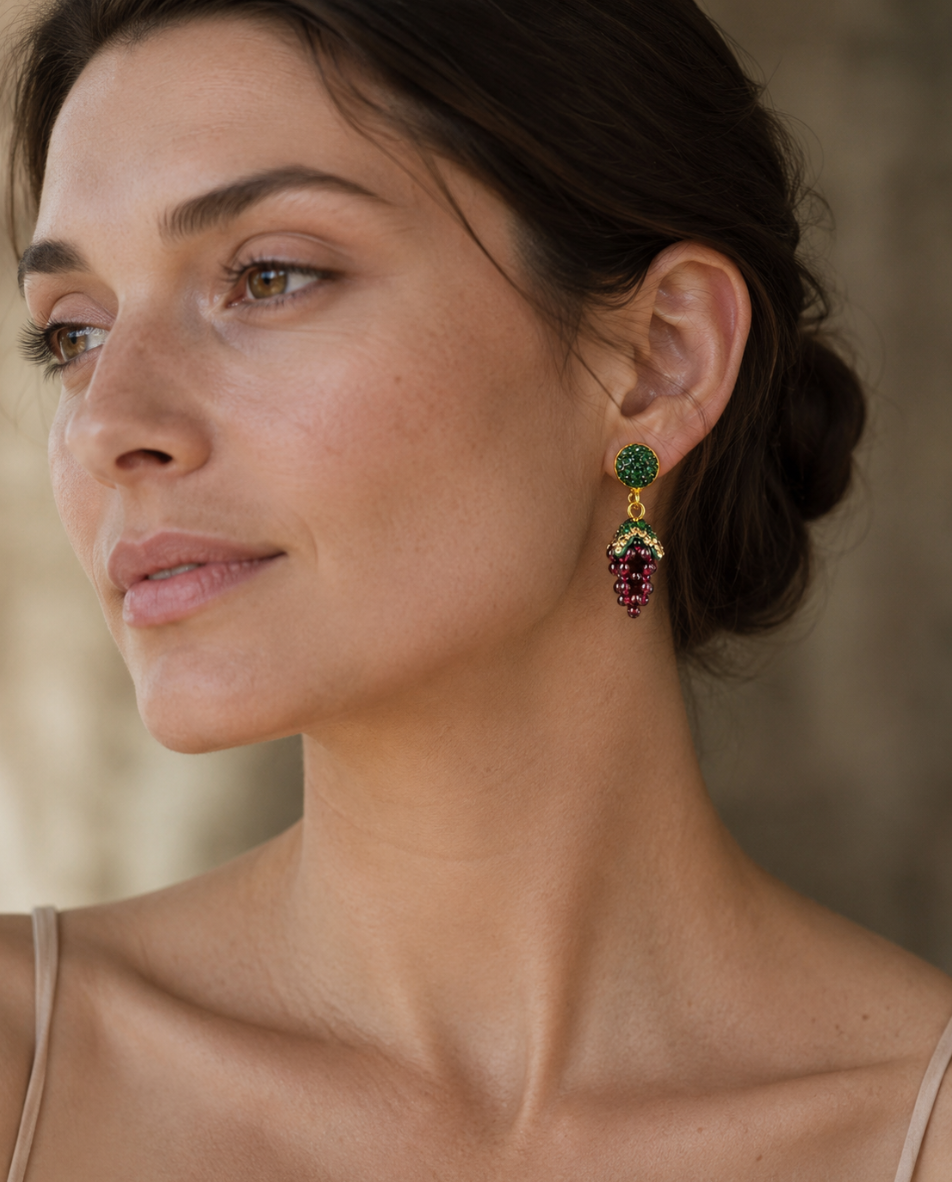 Deep red garnet jewelry earrings styled on a feminine shoulder with soft light