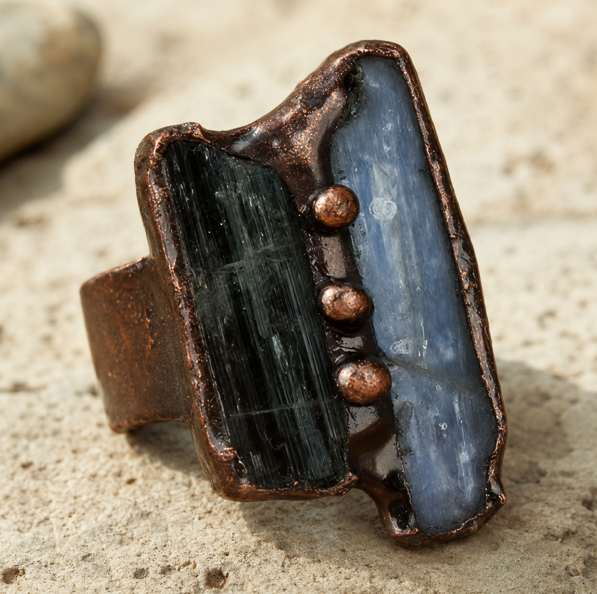 Blue crystal ring with green tourmaline contrast, organic texture, and sculptural handmade jewelry mood.