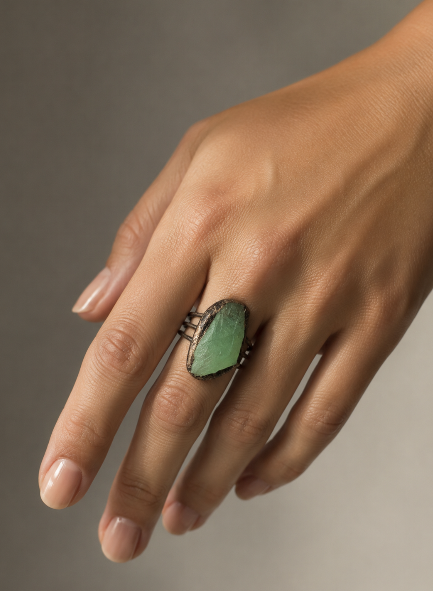 Raw crystal ring with green stone ring character, earthy setting, and soft botanical mood.