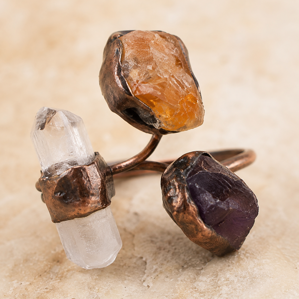 Tri-color gemstone ring featuring amethyst, citrine, and clear quartz with organic raw stone texture.
