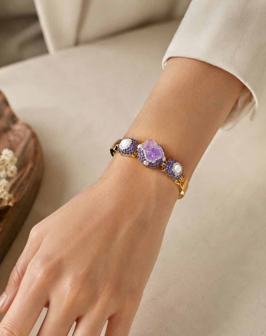 Purple crystal bracelet for women featuring raw amethyst texture, pearl details, and refined evening light.