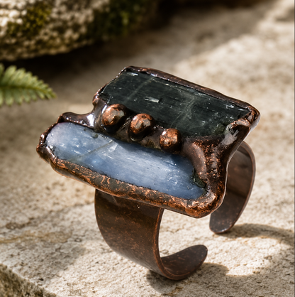 Green blue gemstone ring featuring vertical raw stones, earthy metal edges, and modern natural styling.