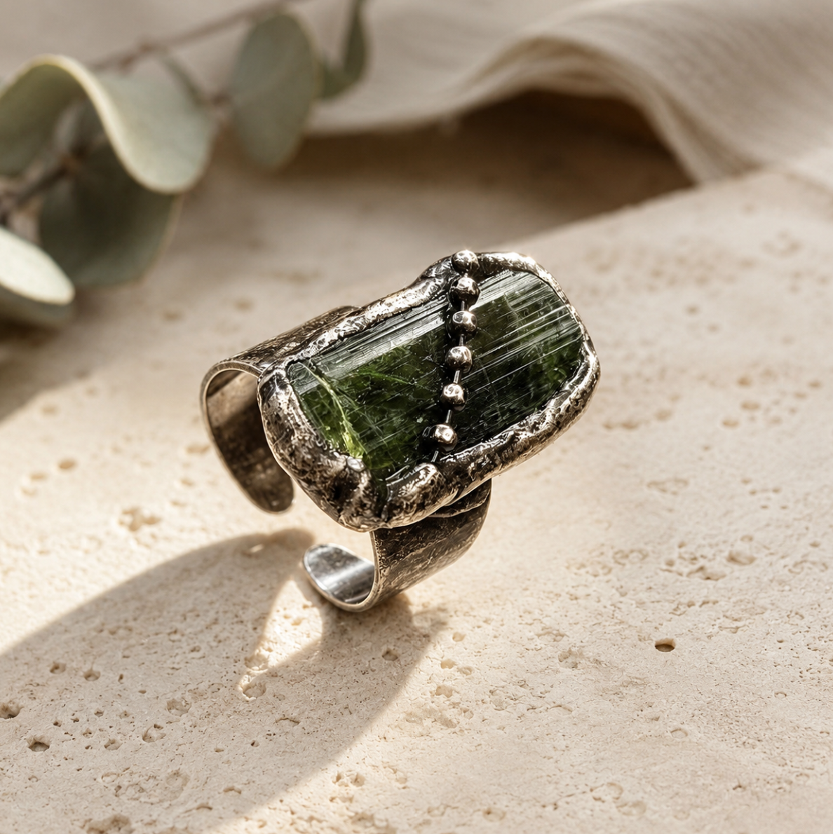 Olive green gemstone ring with rustic edges, bead accents, and organic handcrafted styling.