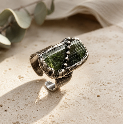 Olive green gemstone ring with rustic edges, bead accents, and organic handcrafted styling.
