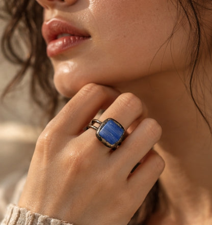 Chunky blue ring worn with a neutral outfit, showing its bold scale and vintage-inspired statement design.