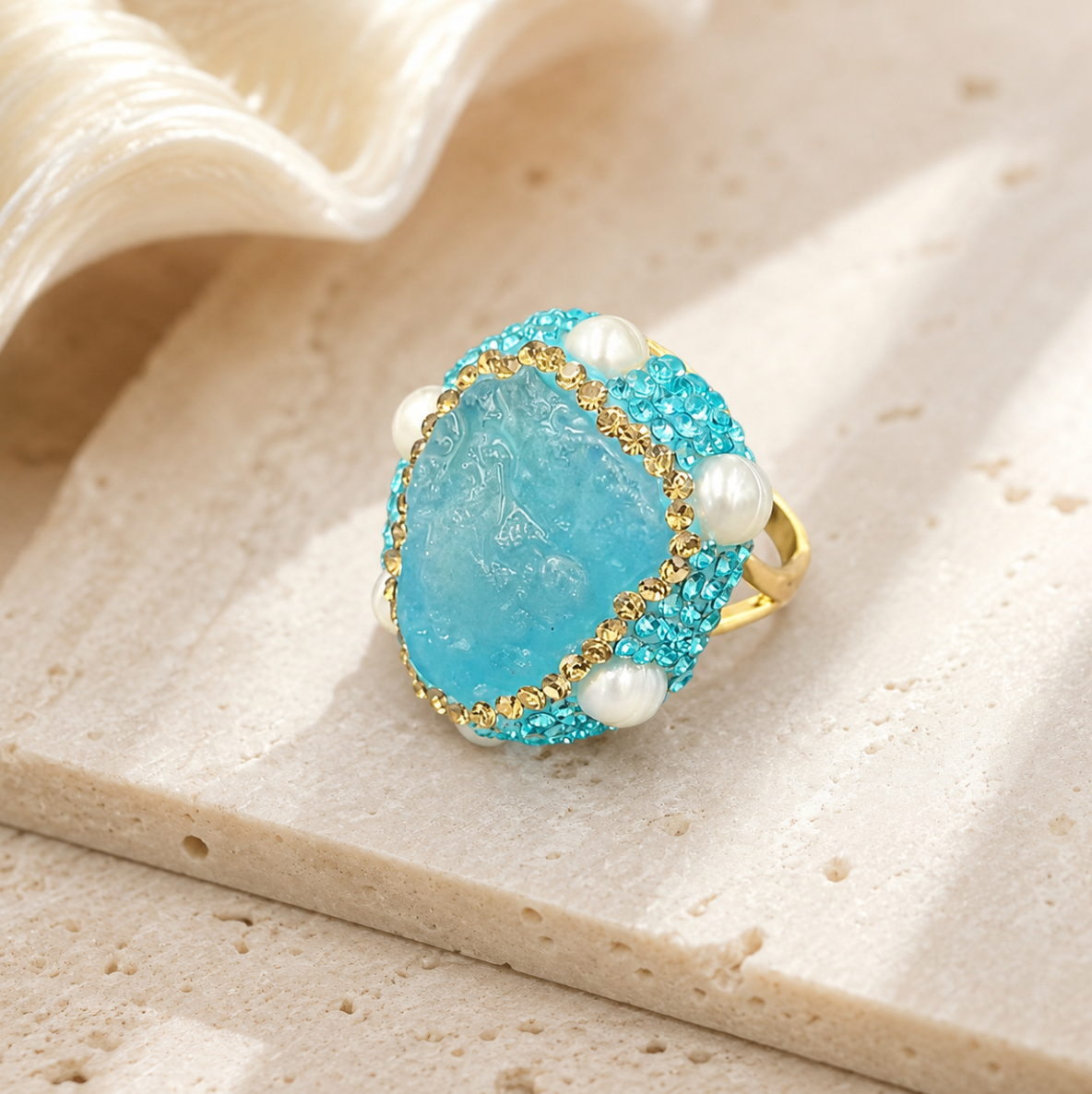 Close-up of aquamarine ring featuring soft blue gemstone and pearl accent