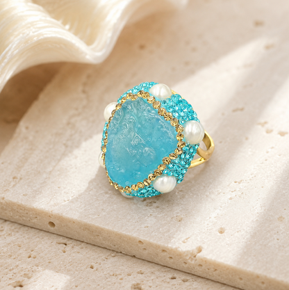 Close-up of aquamarine ring featuring soft blue gemstone and pearl accent