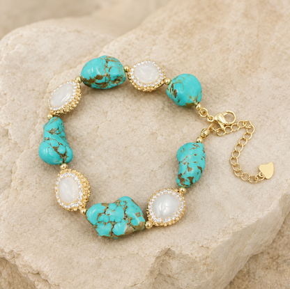 Turquoise bracelet set styled with blue green stones, baroque pearl accents, and soft luxury texture.