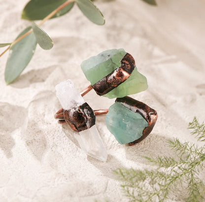 Clear quartz ring paired with green fluorite ring elements in a fresh nature-inspired crystal style.