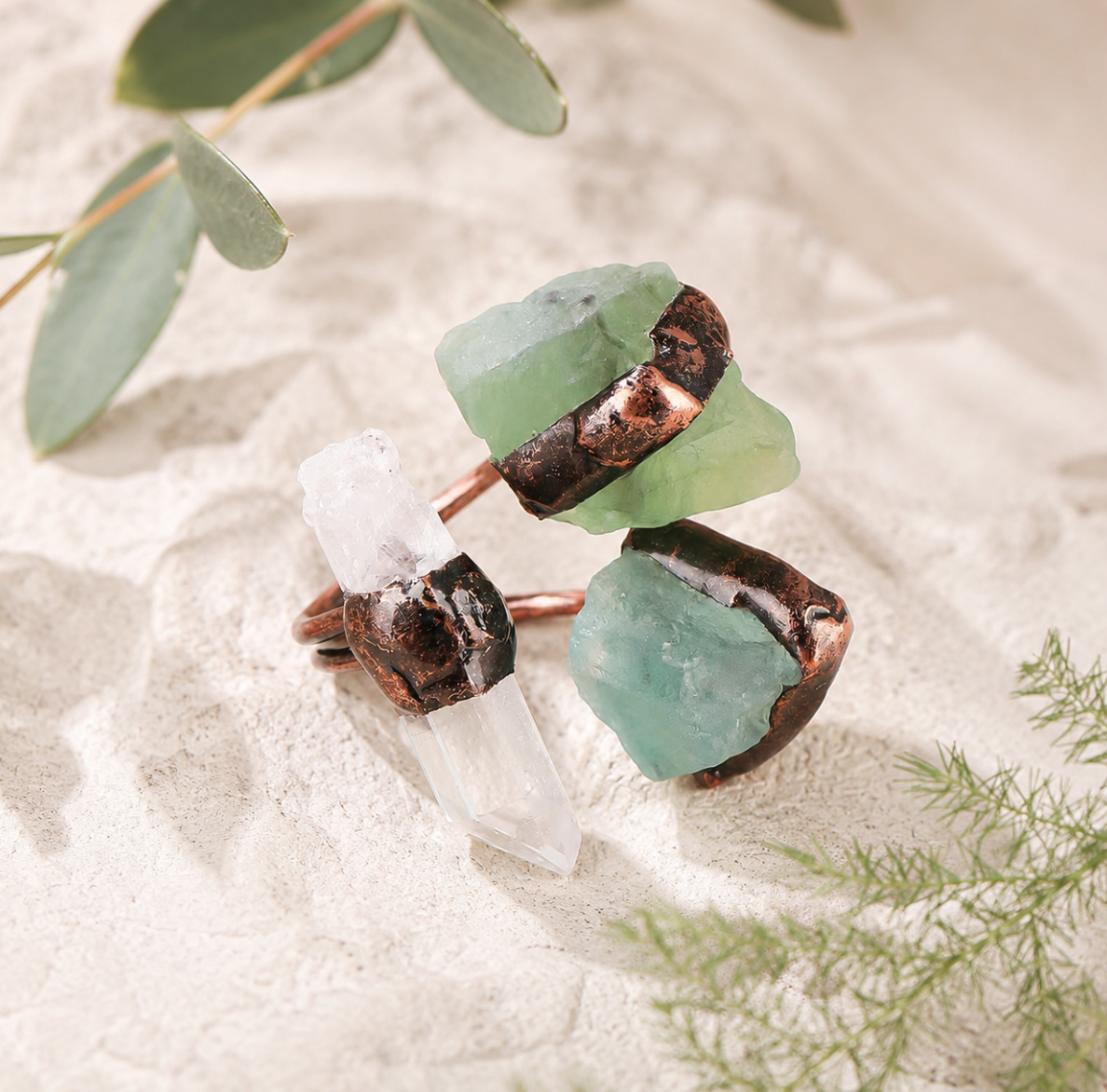 Clear quartz ring paired with green fluorite ring elements in a fresh nature-inspired crystal style.