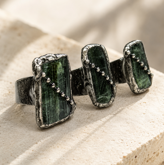 Green tourmaline ring with raw olive stones, vintage-toned setting, and delicate bead-like details.