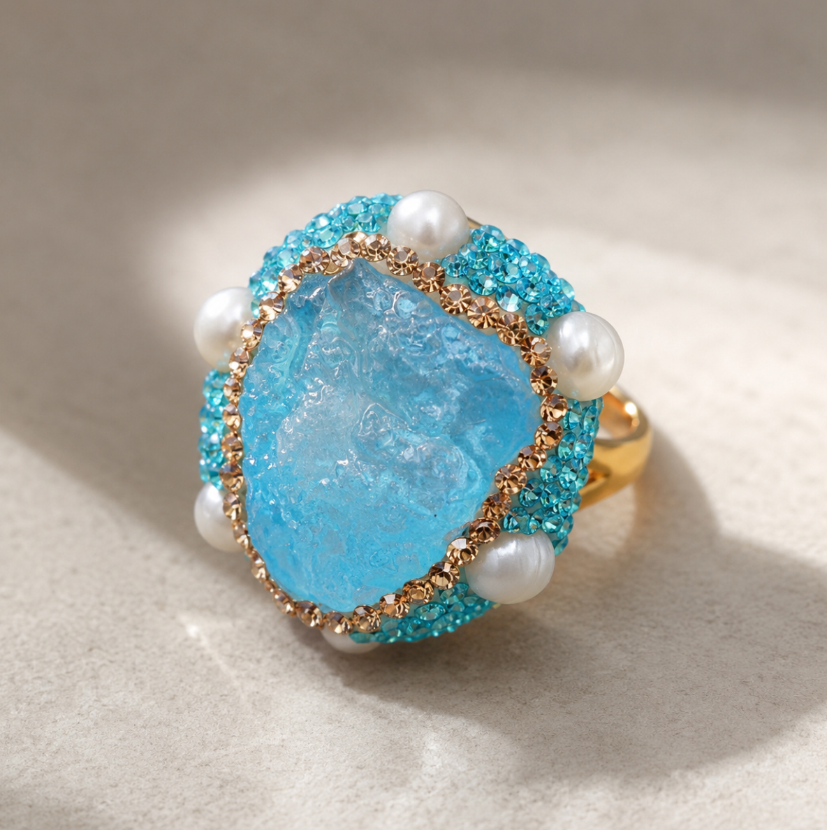 Close-up of aquamarine ring featuring soft blue gemstone and pearl accent