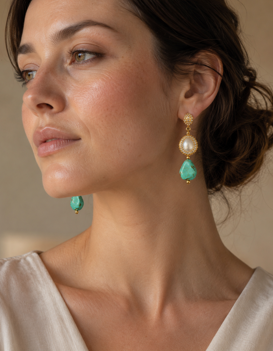 Refined turquoise earrings set with teardrop turquoise stones, pearl accents, and vintage gold details.