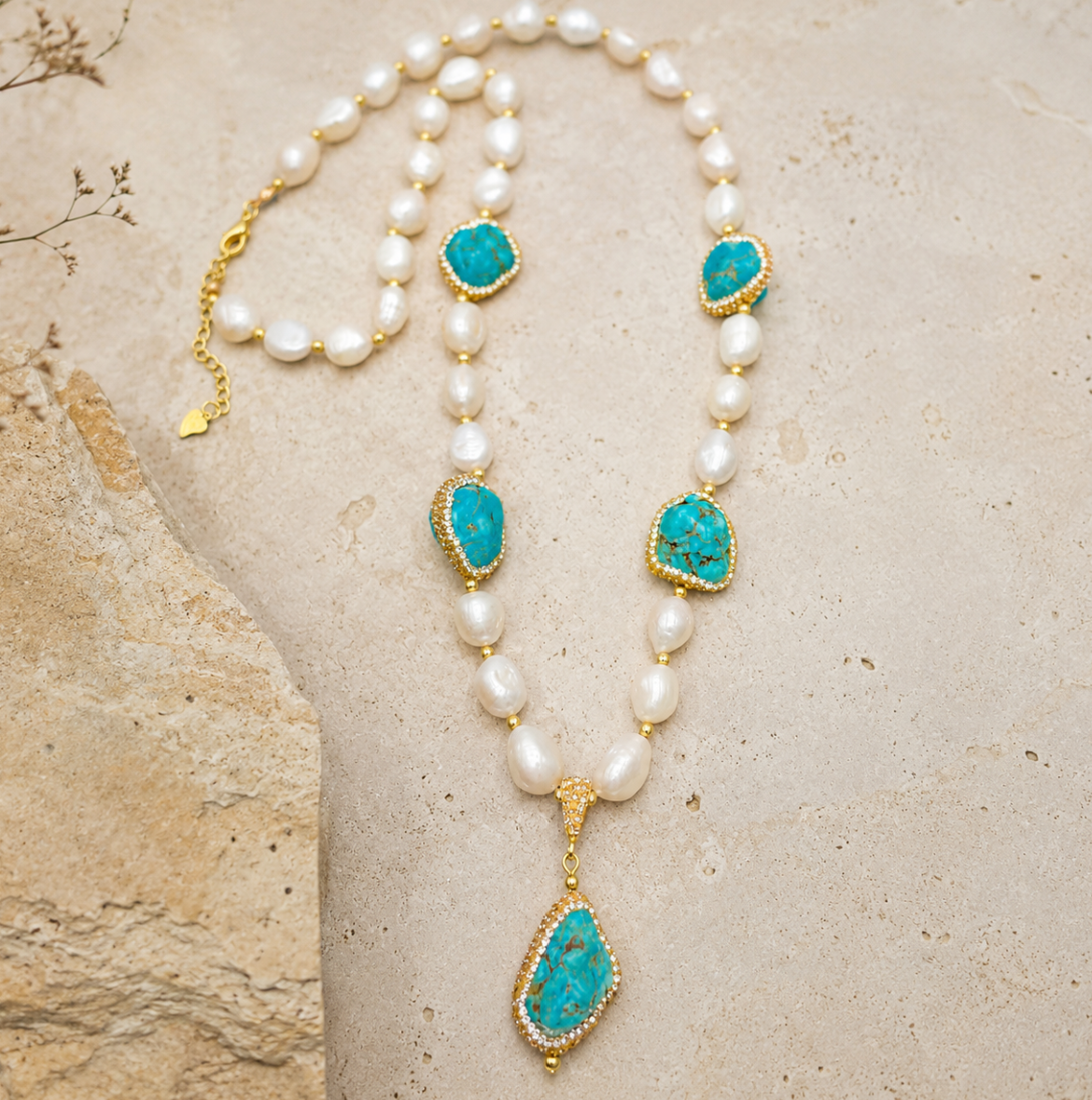 Pearl and turquoise jewelry set featuring baroque pearl beads, turquoise accents, and warm gold details.