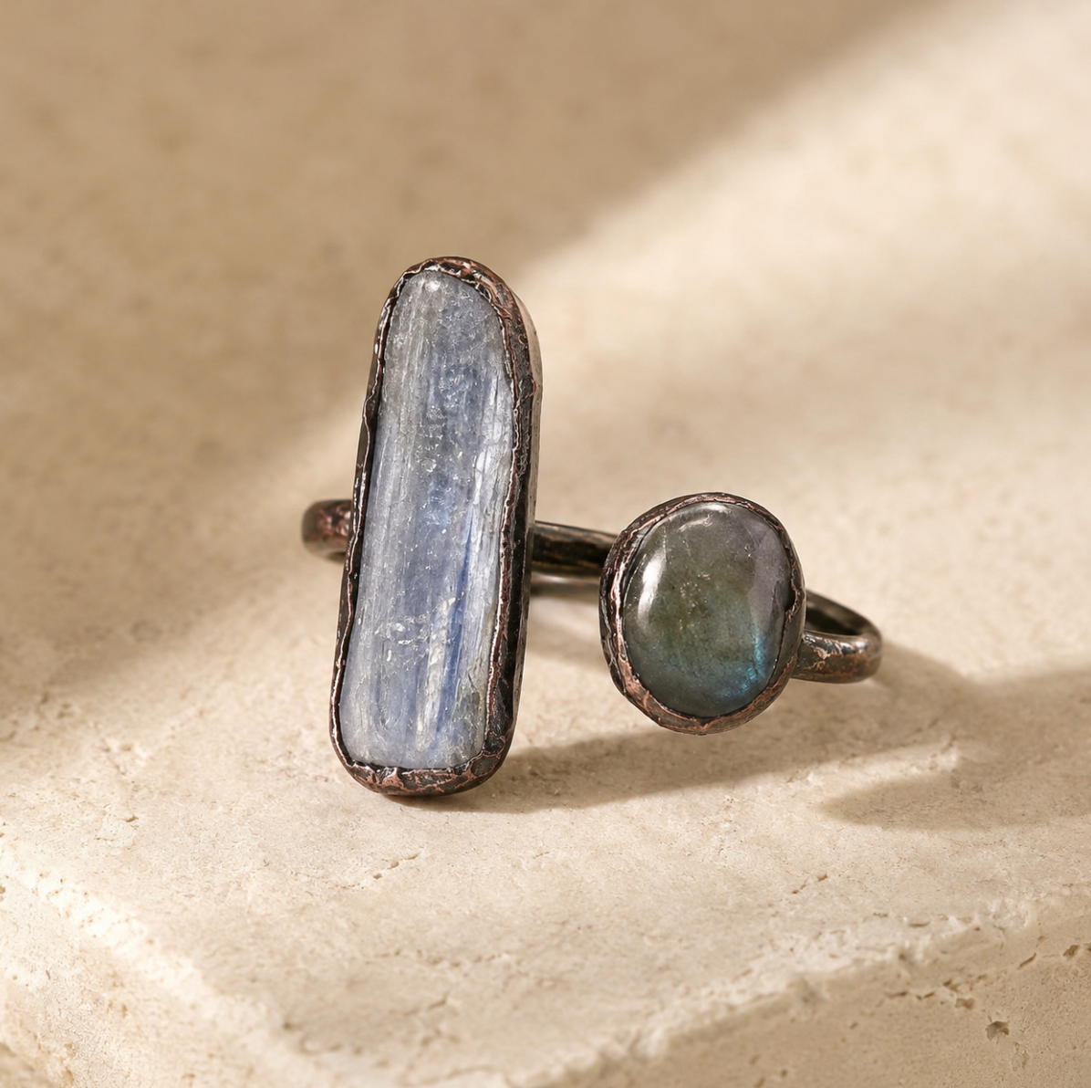 Labradorite blue crystal ring with elongated labradorite stone, round blue crystal, and rustic metal setting.