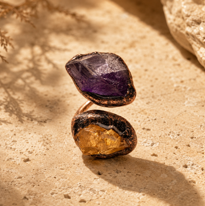 Amethyst citrine ring with raw purple amethyst, golden citrine stone, and sculptural open-band design.