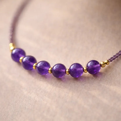 february birthstone necklace with small amethyst beads and refined detail