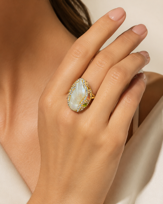 Model wearing colored gemstone ring on elegant hand