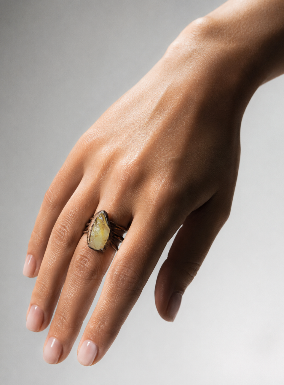 Yellow crystal ring with gold tone gemstone ring glow, natural mineral texture, and soft light.