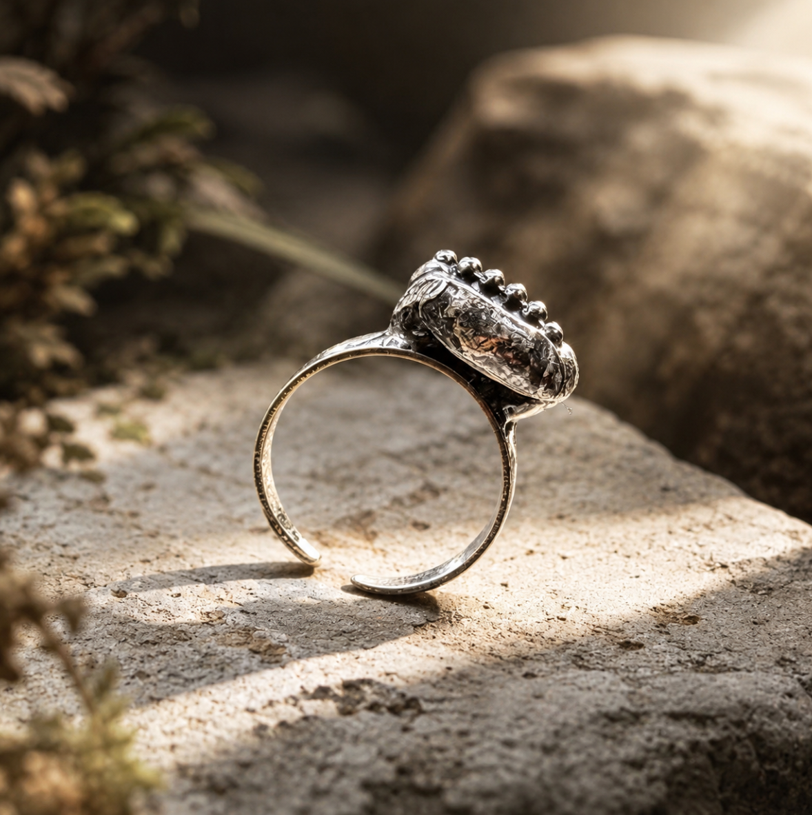 Bohemian gemstone ring with verdant green stones, irregular shape, and antique-inspired finish.