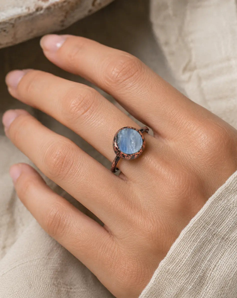 Blue gemstone ring with circular gemstone ring design, soft blue shine, and minimalist elegance.