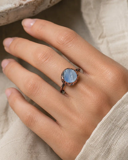 Blue gemstone ring with circular gemstone ring design, soft blue shine, and minimalist elegance.