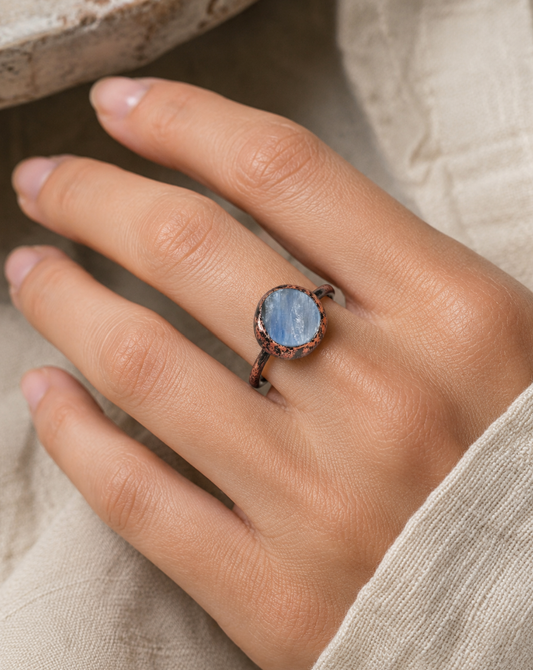 Blue gemstone ring with circular gemstone ring design, soft blue shine, and minimalist elegance.