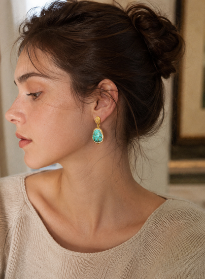Close-up of turquoise stone earrings highlighting organic pattern