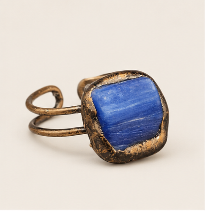 Midnight Pool blue stone ring with a deep blue square crystal and vintage double-band setting on warm off-white.