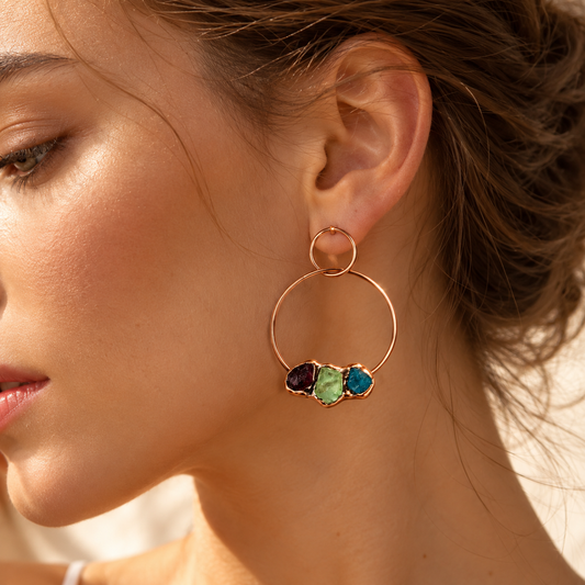 Large hoop earrings worn beside the face, showing three colorful gemstones and their real wearing scale.
