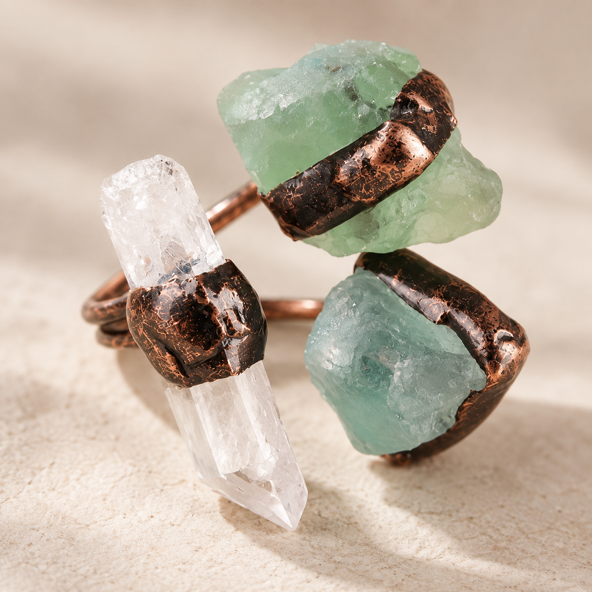 Macro view of a three stone ring with clear quartz and green fluorite, showing irregular surfaces and natural texture.