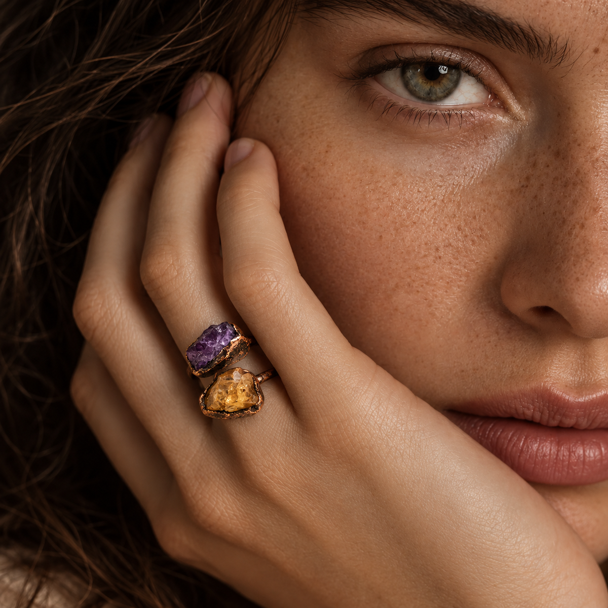 Statement ring worn with a neutral outfit, showing the bold amethyst and citrine stones as the focal point.