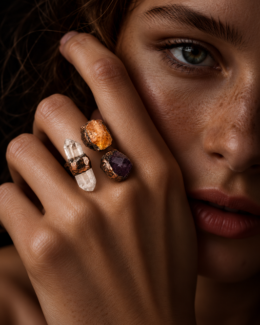 Close-up of a statement ring worn on the hand, showing three raw stones and the open branching structure.
