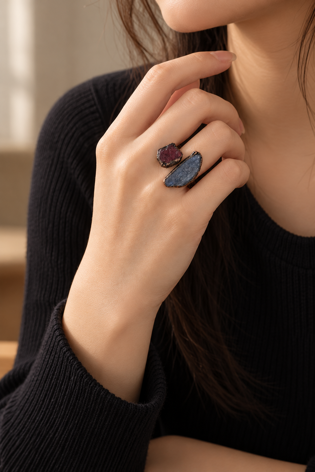 Crimson Tide red stone and blue kyanite ring worn with a black knit top.