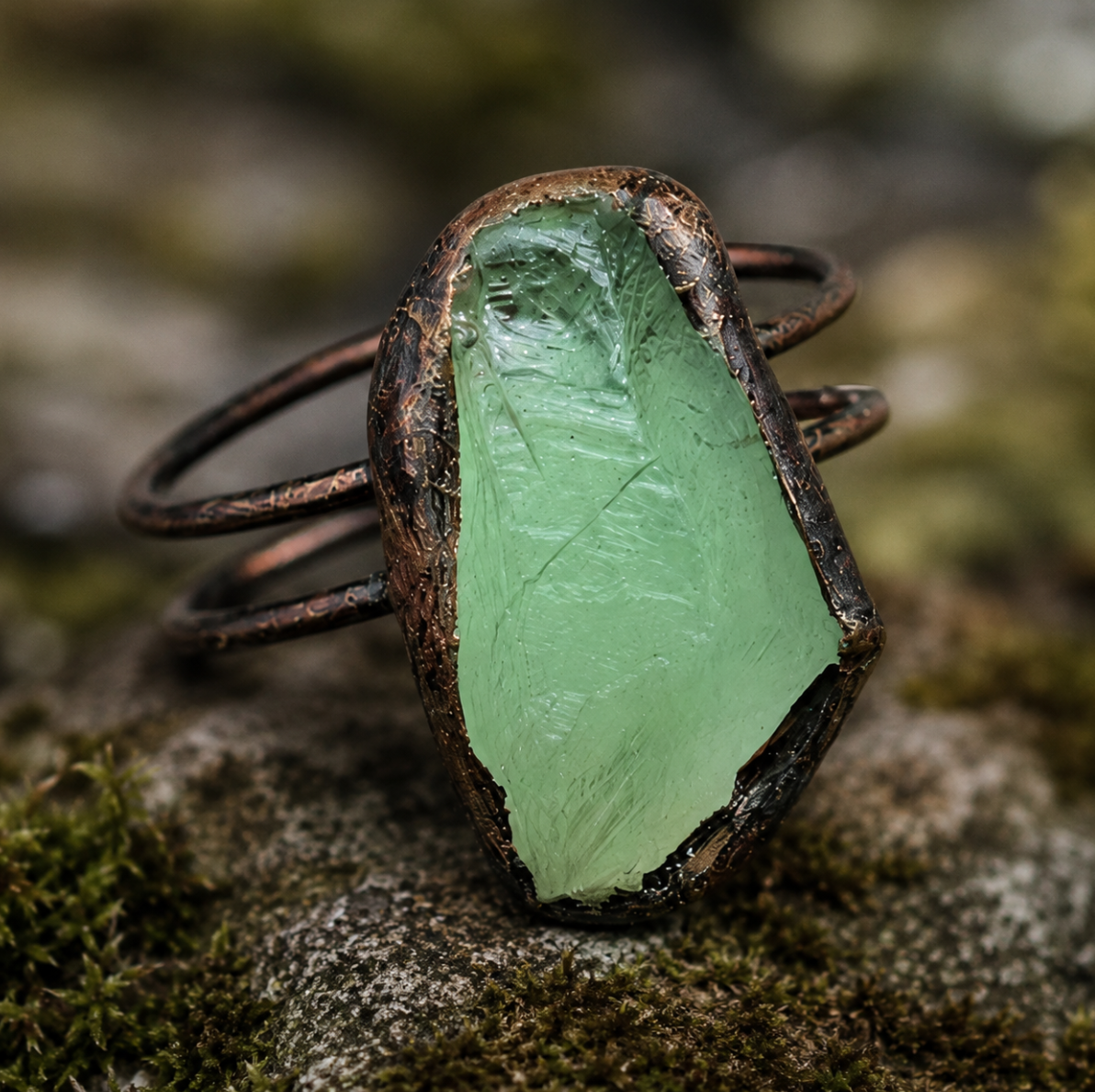 Green fluorite ring with raw moss-green crystal, organic stone edges, and nature-inspired styling.