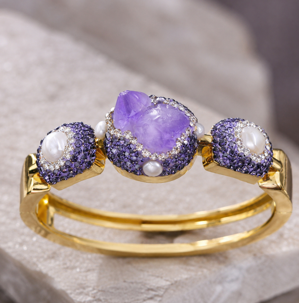Amethyst french bracelet with raw purple crystal center, pearl accents, and gold-tone French cuff design.