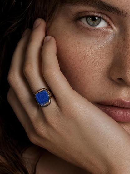 Blue gemstone ring styled on the hand with rich color, soft shadows, and elegant everyday mood.