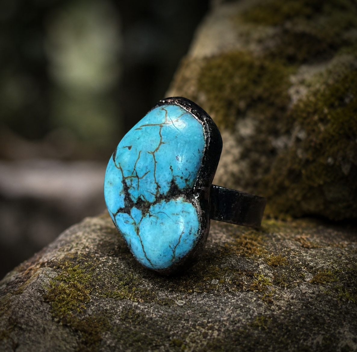 Natural turquoise ring displayed on mossy wood with raw turquoise color and quiet nature-inspired elegance.